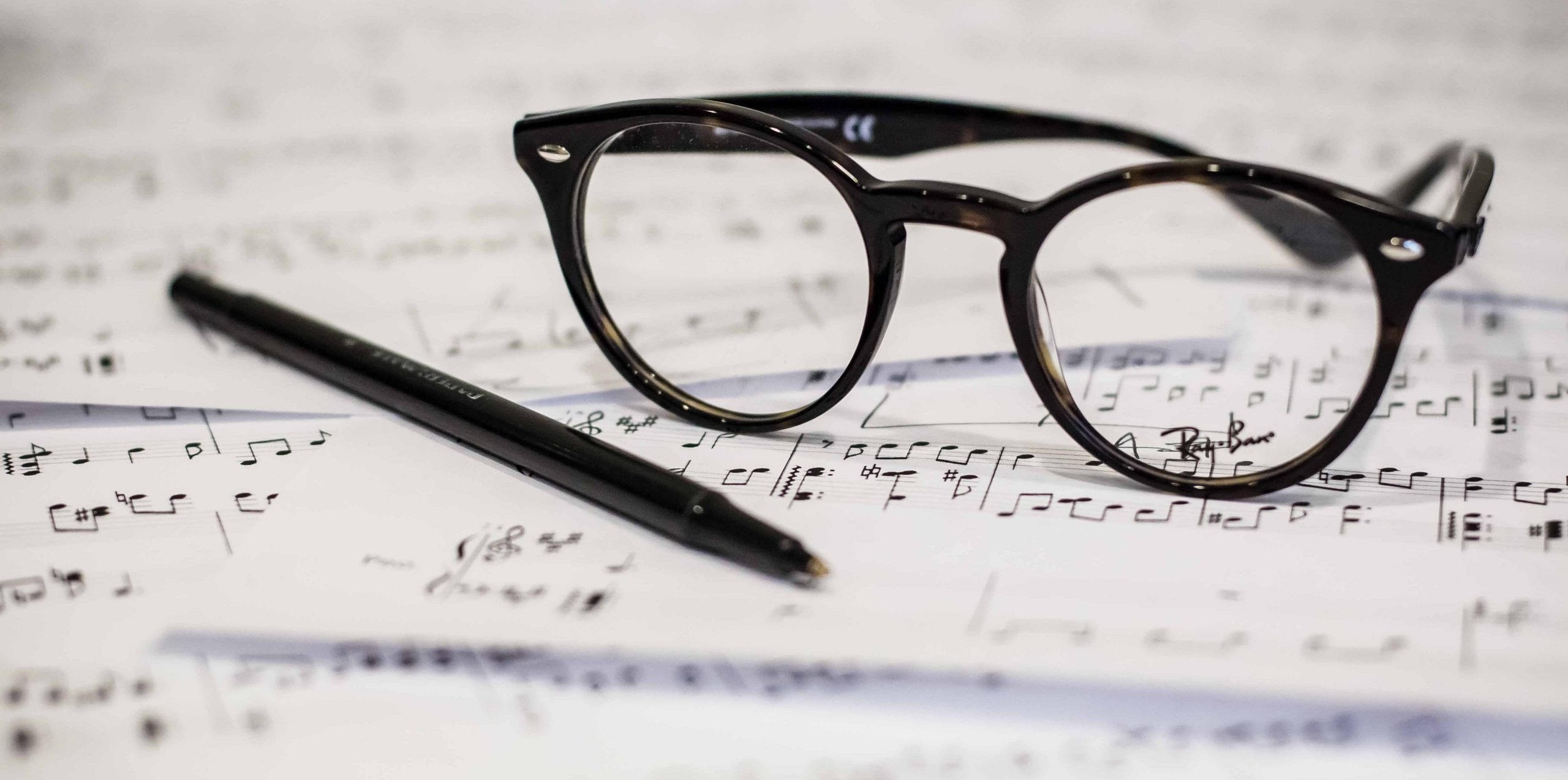 spectacles and written music notes